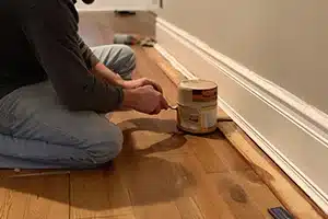 Finishing touches on newly installed baseboards