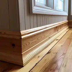 Pine baseboard installation in a home