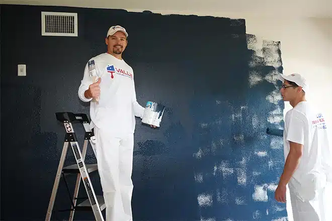 Value Painting and Flooring workers smiling during an interior house painting project