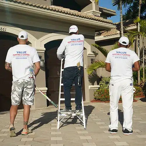 Value Painting and Flooring workers smiling for the camera